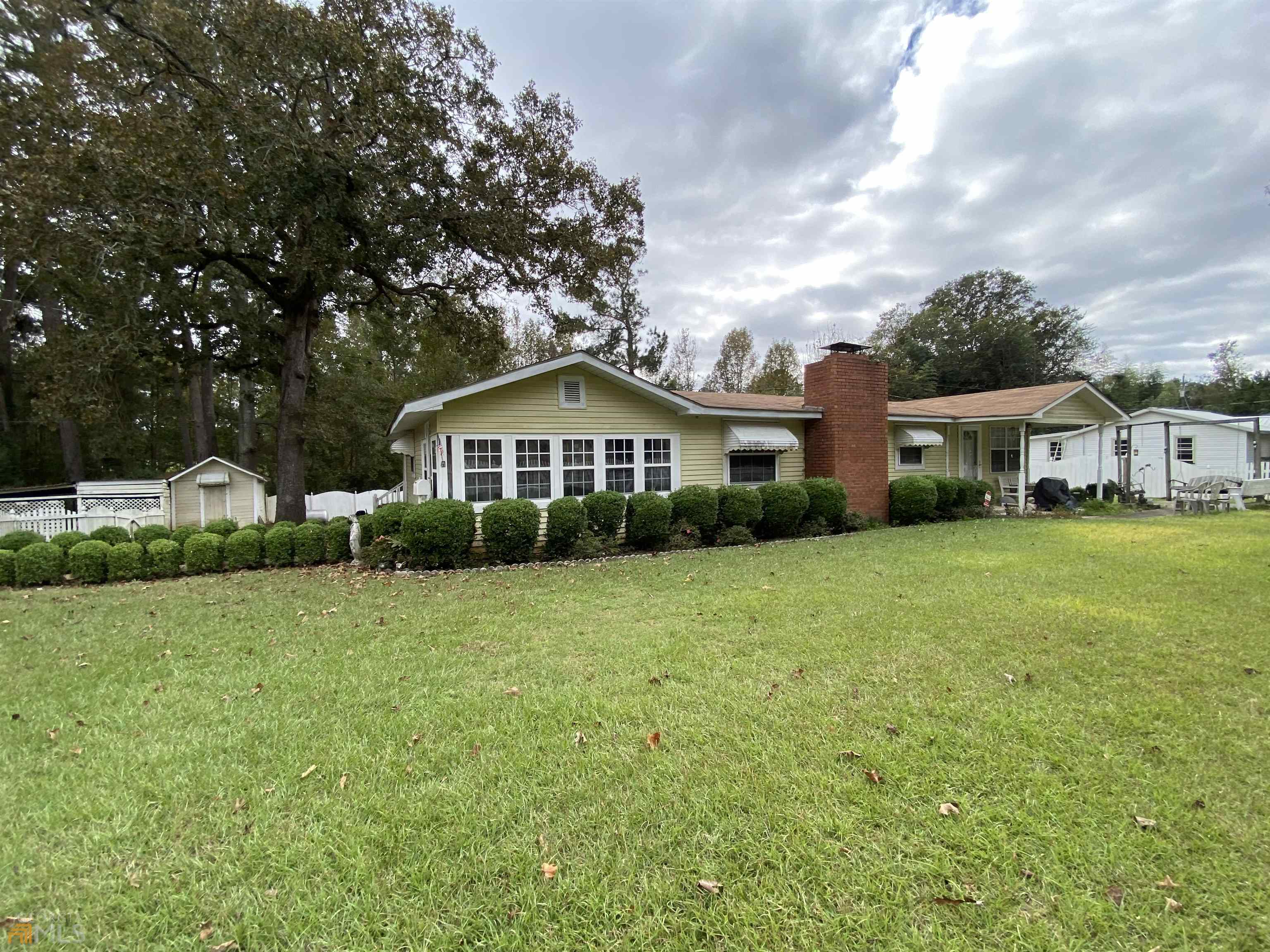 136 Faulk Road Cochran, GA 31014 - Photo 1 of 1 a front view of a house with yard and green space