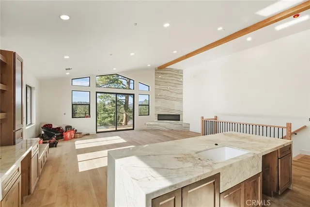 an aerial view of residential house with yard and mountain view in back