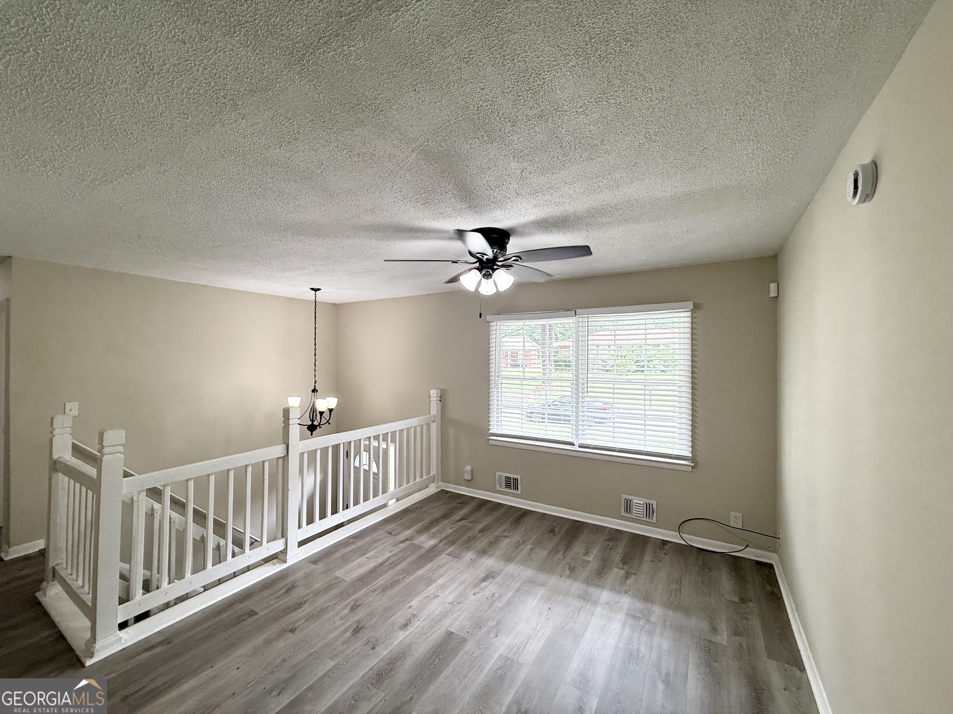 2782 Ocean Valley Road Atlanta, GA 30349 - Photo 6 of 27 a view of an empty room with wooden floor and a window