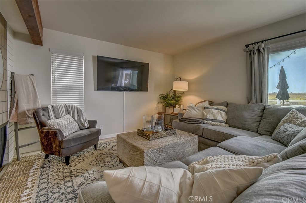 401 Canal Street Newport Beach, CA 92663 - Photo 12 of 27 a living room with a couch and a flat screen tv