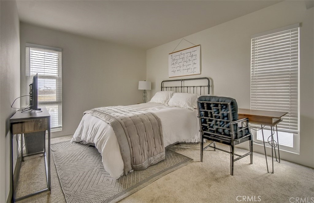 401 Canal Street Newport Beach, CA 92663 - Photo 25 of 27 a bedroom with a bed chair and window