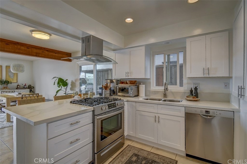 401 Canal Street Newport Beach, CA 92663 - Photo 5 of 27 a kitchen with a stove sink and cabinets