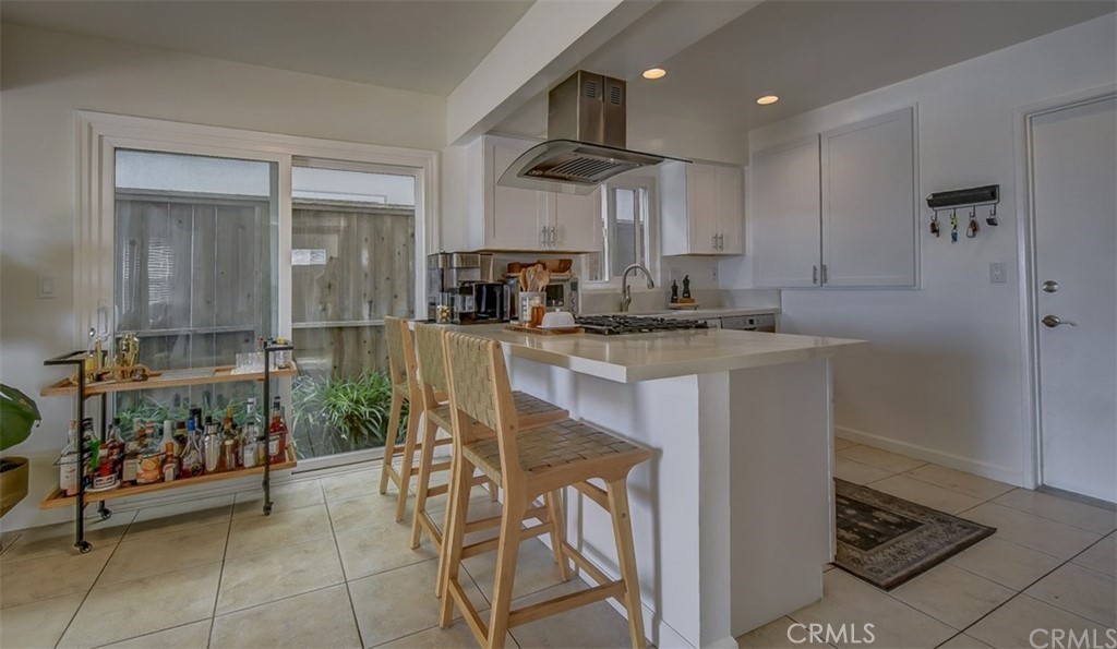 401 Canal Street Newport Beach, CA 92663 - Photo 6 of 27 a kitchen with stainless steel appliances kitchen island granite countertop a sink and cabinets
