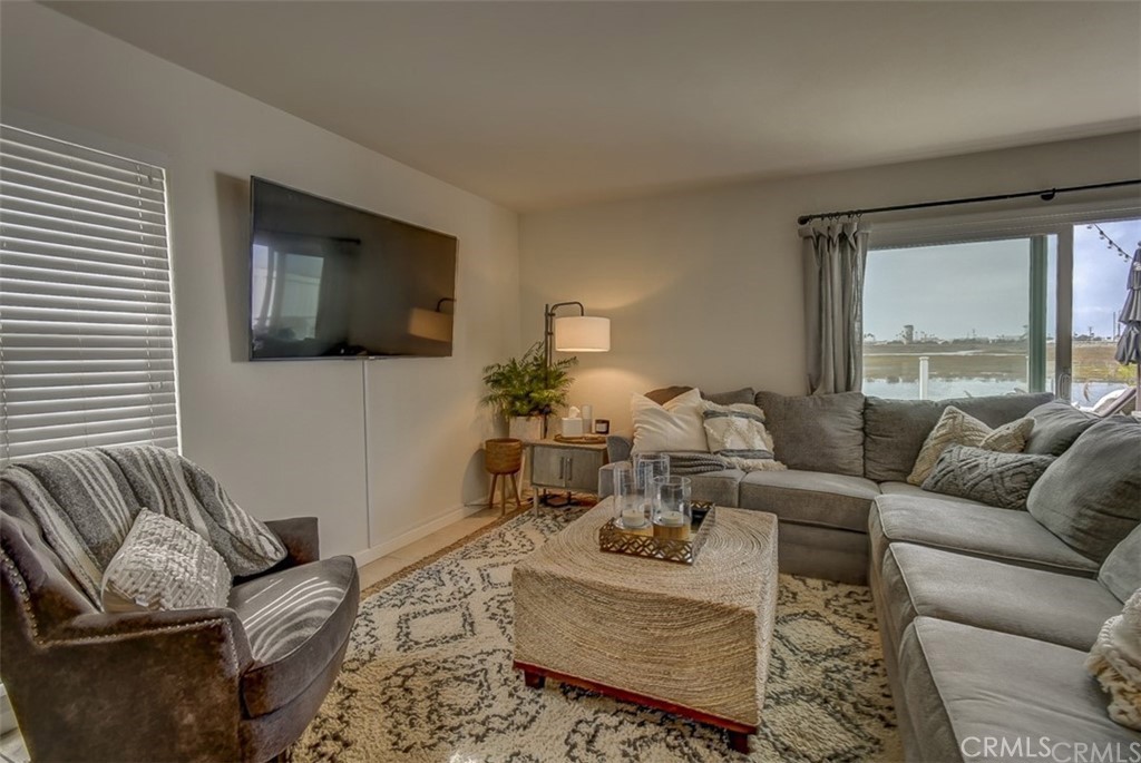 401 Canal Street Newport Beach, CA 92663 - Photo 10 of 27 a living room with furniture or couch and a flat screen tv