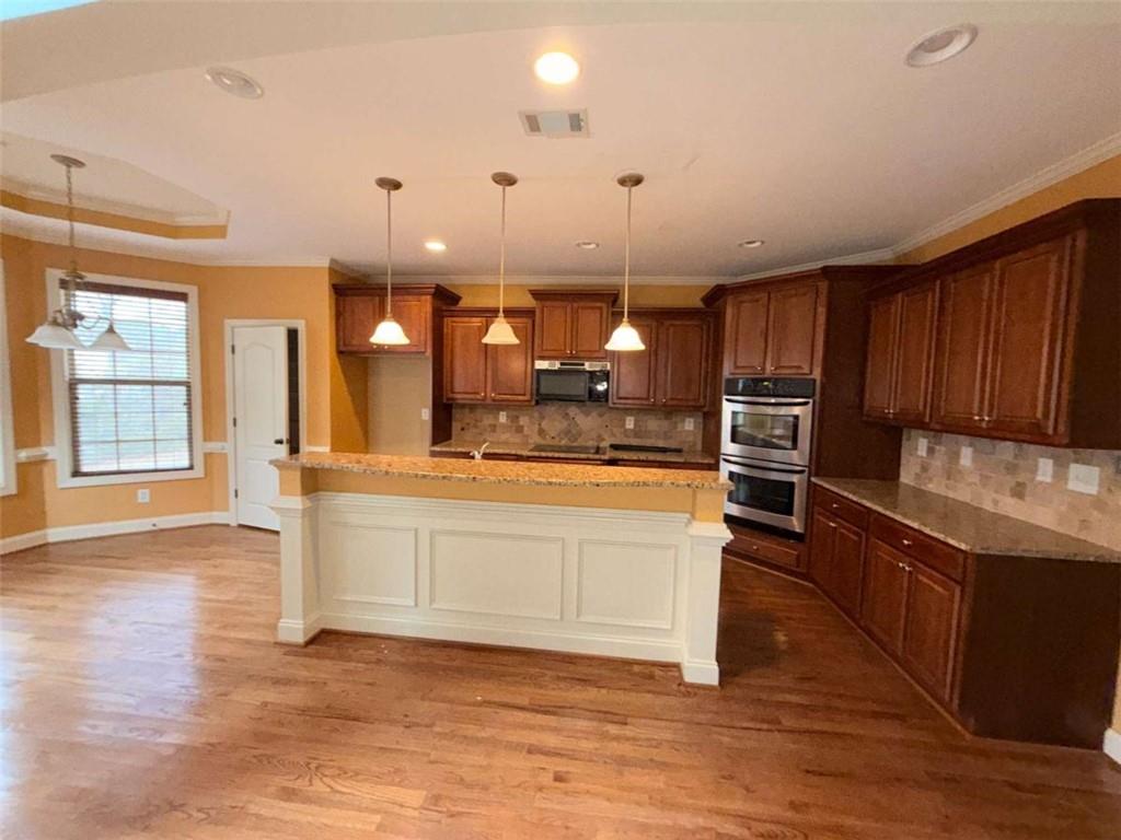 75 Cannonade Court Covington, GA 30016 - Photo 12 of 20 a kitchen with stainless steel appliances kitchen island granite countertop a stove a sink and a refrigerator
