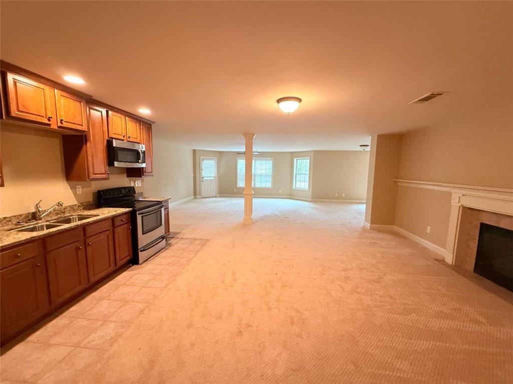 75 Cannonade Court Covington, GA 30016 - Photo 7 of 20 a large kitchen with stainless steel appliances granite countertop a sink and cabinets