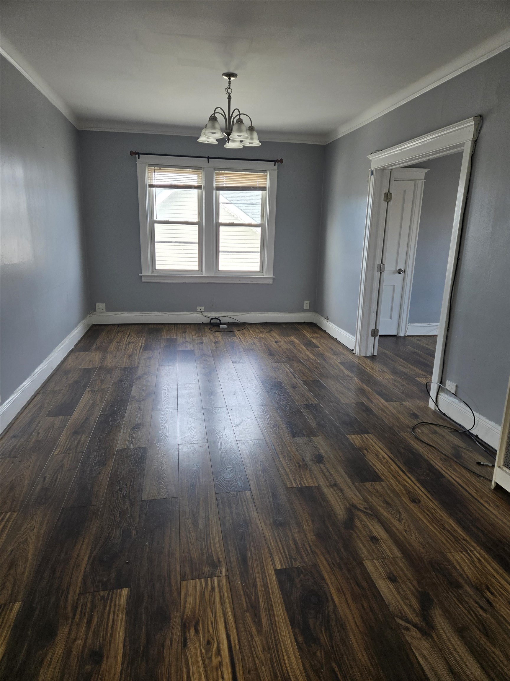 1205 73rd Street, Unit 2 North Bergen, NJ 07047 - Photo 4 of 8 an empty room with wooden floor and windows