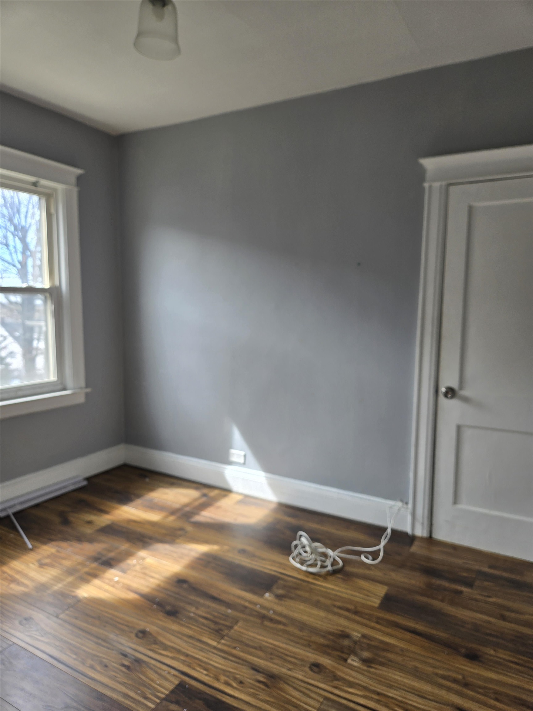 1205 73rd Street, Unit 2 North Bergen, NJ 07047 - Photo 7 of 8 an empty room with wooden floor and windows