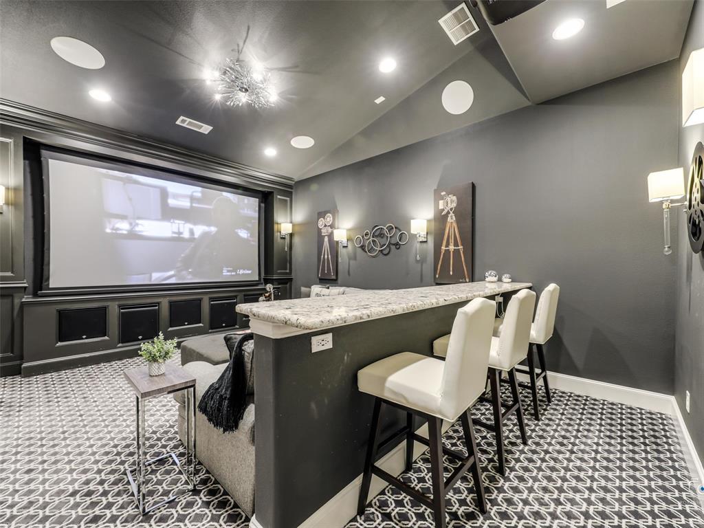 3117 Callander The Colony, TX 75056 - Photo 10 of 40 Downstairs media room with bar seating. Projector and AV equipment conveys.