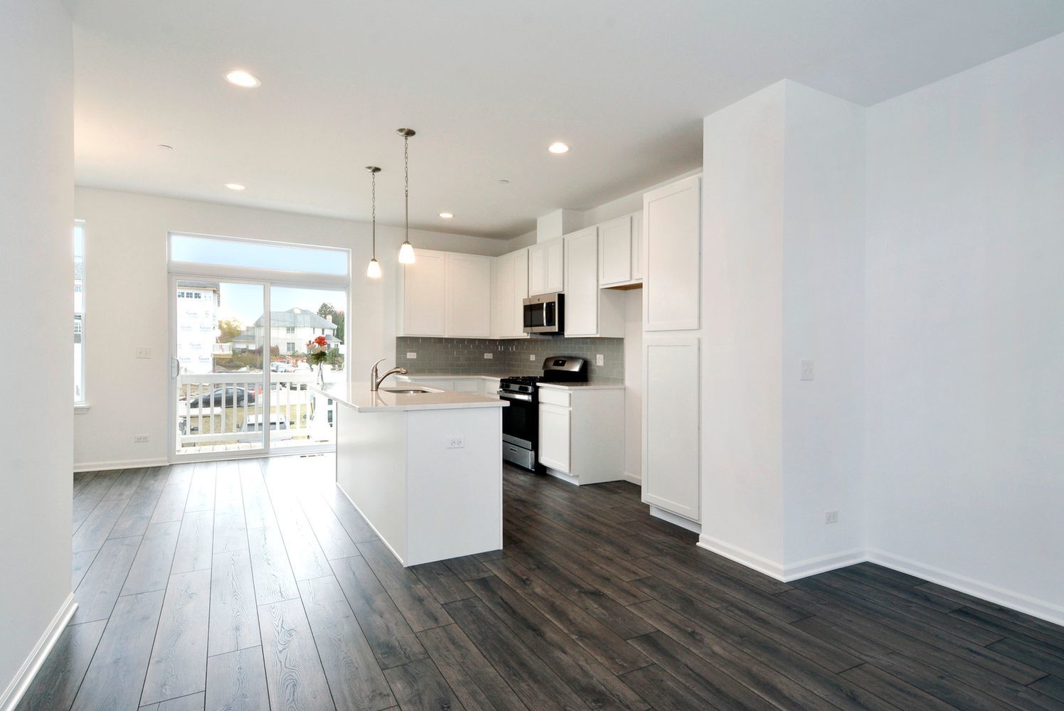202 Timberleaf Circle Roselle, IL 60172 - Photo 4 of 14 a kitchen with stainless steel appliances granite countertop a refrigerator a sink dishwasher a stove and white countertops with wooden floor