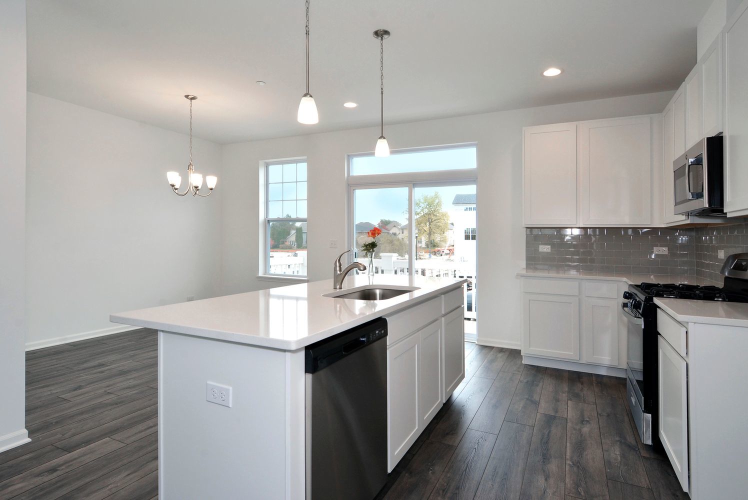 202 Timberleaf Circle Roselle, IL 60172 - Photo 5 of 14 a kitchen with kitchen island granite countertop a sink appliances and cabinets
