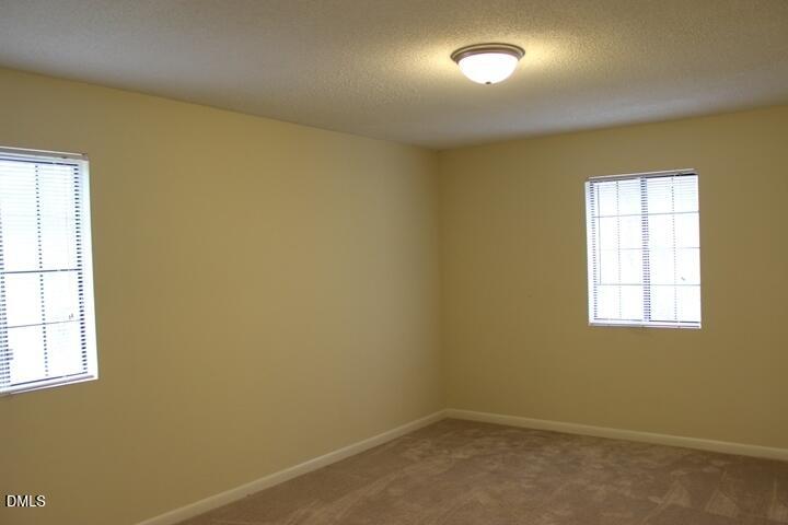 203 East Ransom Street, Unit 3D Fuquay-Varina, NC 27526 - Photo 8 of 10 an empty room with a empty space and a window