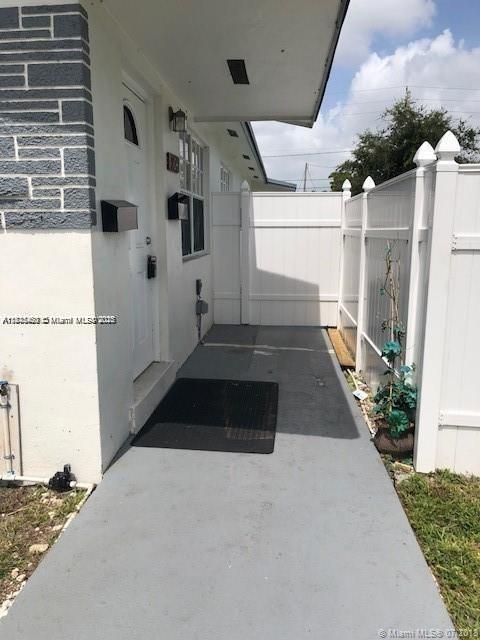904 Southwest 7th Terrace, Unit 1 Hallandale Beach, FL 33009 - Photo 1 of 11 a black car parked in front of a building