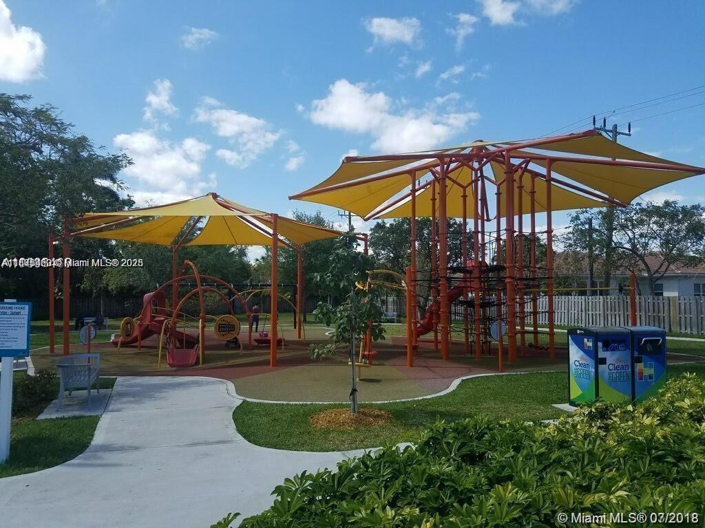 904 Southwest 7th Terrace, Unit 1 Hallandale Beach, FL 33009 - Photo 11 of 11 a view of a park with swings and slides