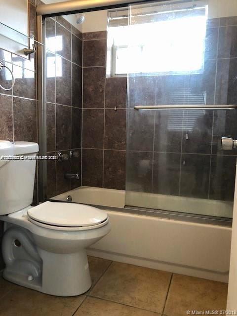 904 Southwest 7th Terrace, Unit 1 Hallandale Beach, FL 33009 - Photo 6 of 11 a bathroom with a toilet and a shower