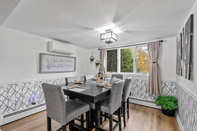 a view of a dining room with furniture window and wooden floor