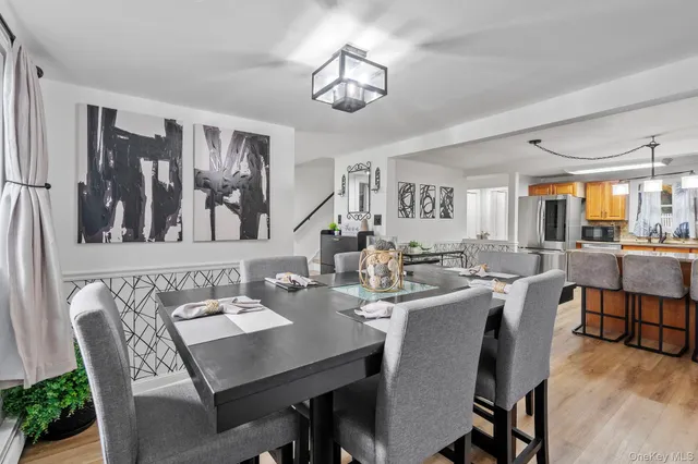 a view of a dining room with furniture and a chandelier