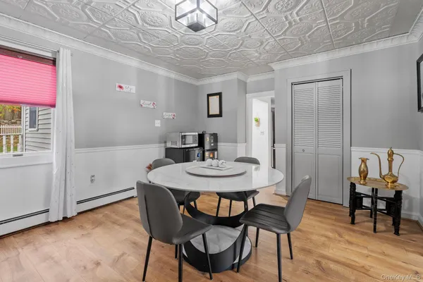 a view of a dining room with furniture and wooden floor