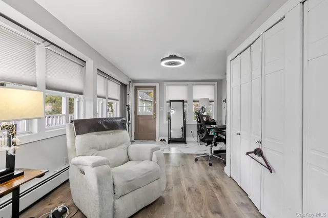 a living room with furniture a wooden floor and a large window
