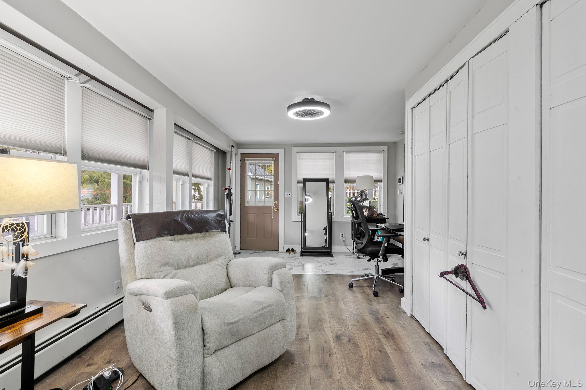 168 Fostertown Road Newburgh, NY 12550 - Photo 19 of 37 a living room with furniture a wooden floor and a large window