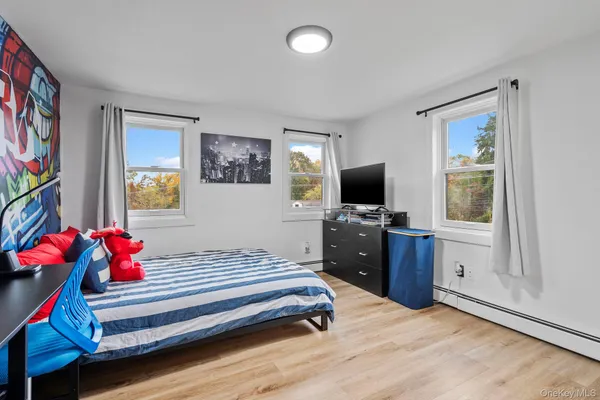 a bedroom with a bed and flat screen tv