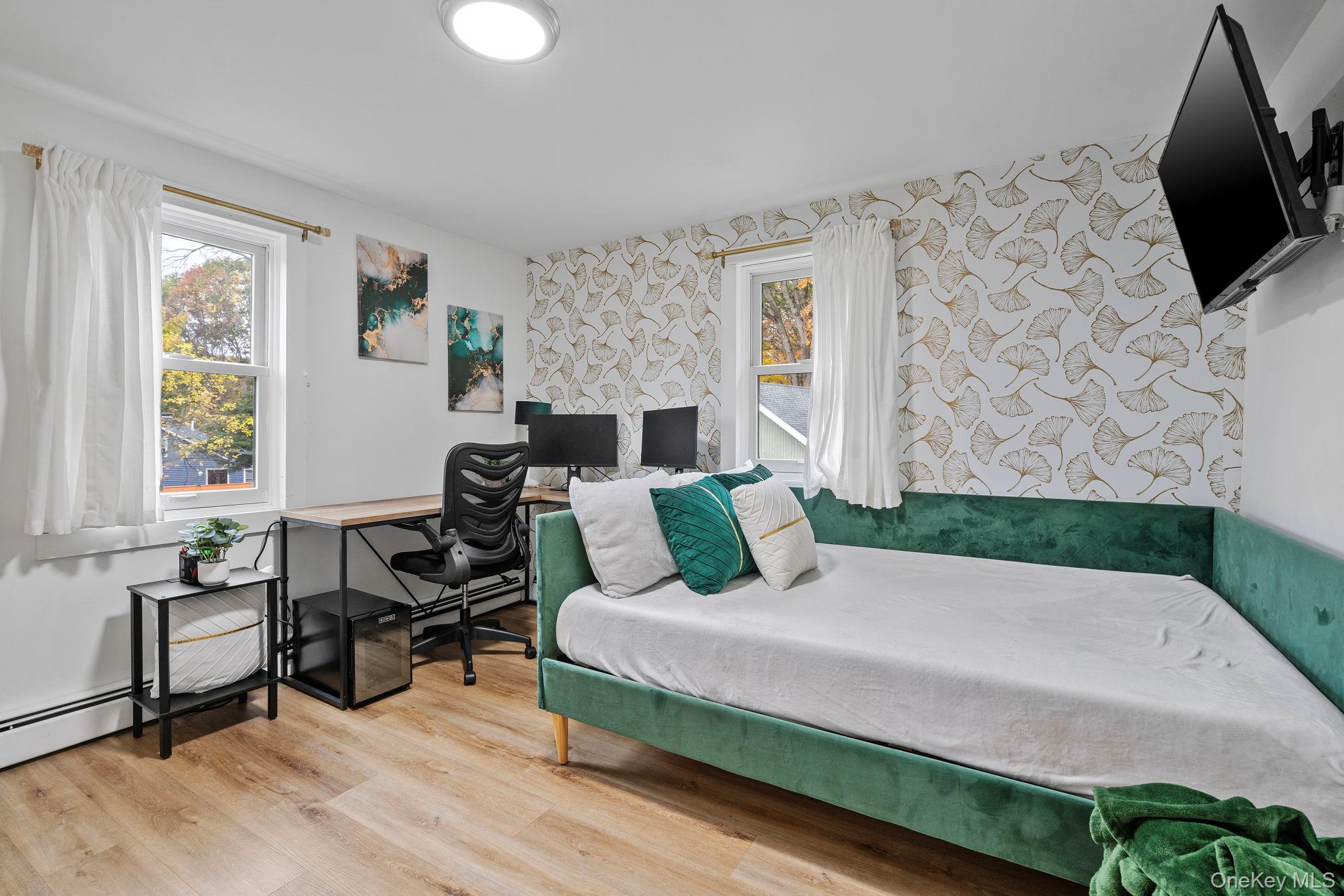 168 Fostertown Road Newburgh, NY 12550 - Photo 25 of 37 a bedroom with a bed a flat screen tv and a fireplace