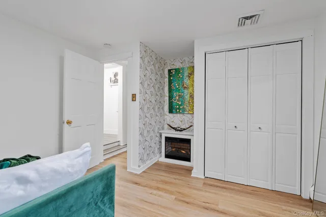 a view of a hallway with wooden floor and a sink