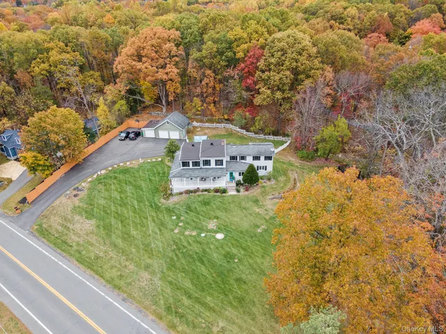 a view of a house with a yard and pathway