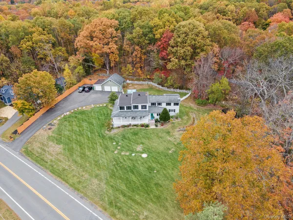 a view of a house with a yard and pathway