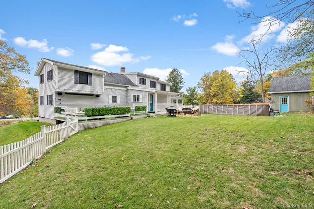 a view of a backyard with chairs and a fire pit