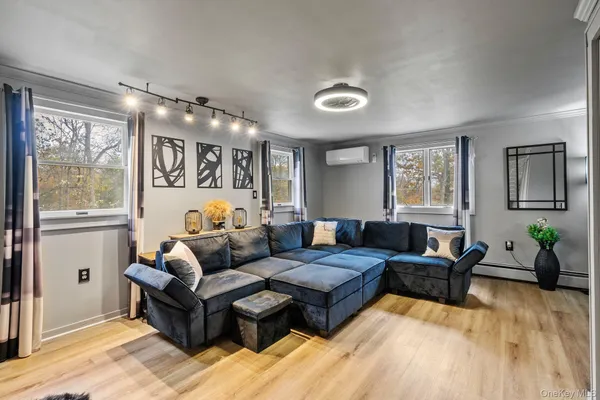 a living room with furniture and wooden floor