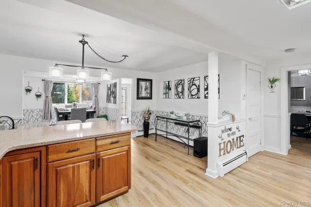 a kitchen with stainless steel appliances a stove a sink dishwasher and white cabinets with wooden floor