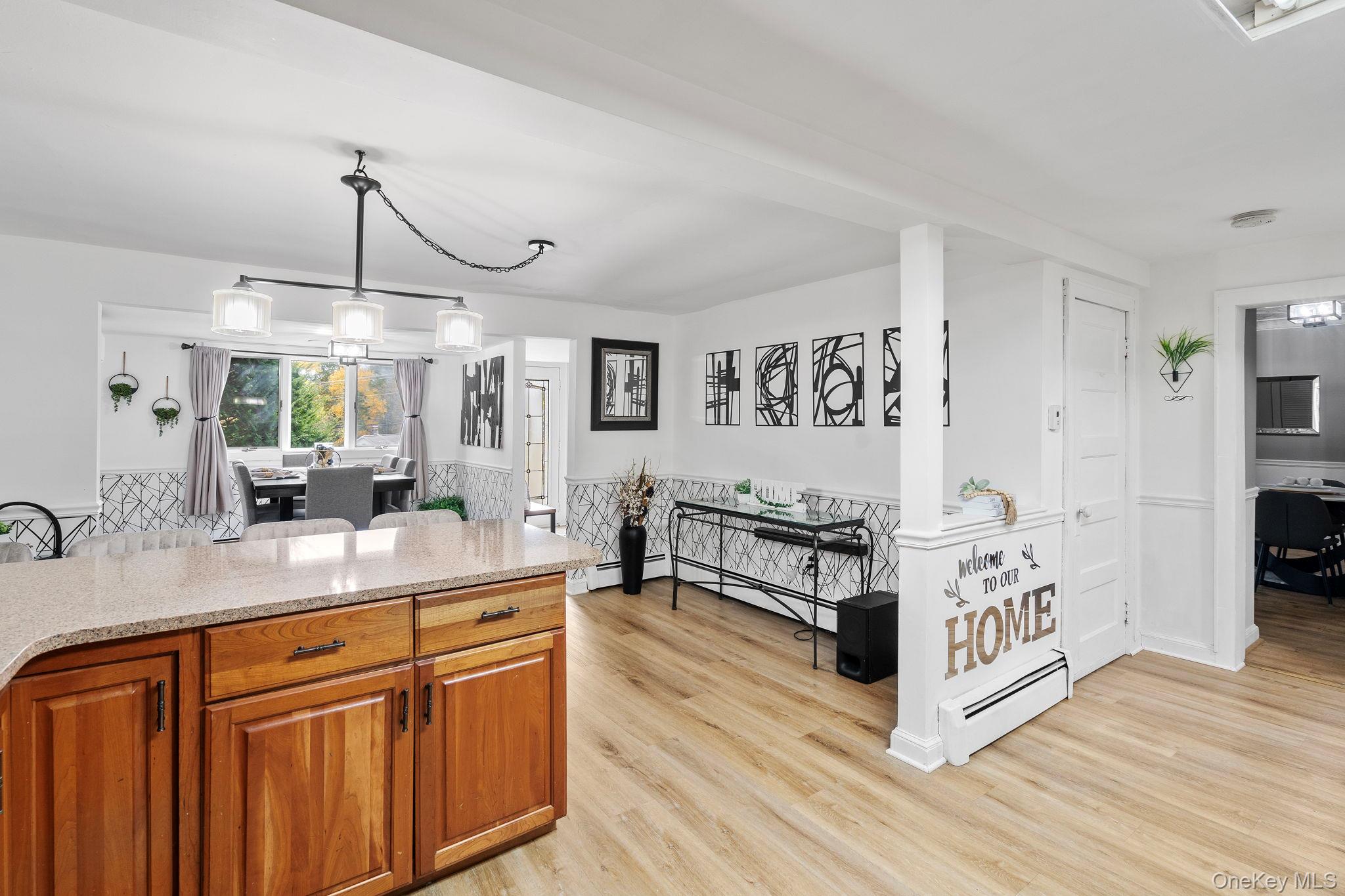 168 Fostertown Road Newburgh, NY 12550 - Photo 8 of 37 a kitchen with stainless steel appliances a stove a sink dishwasher and white cabinets with wooden floor