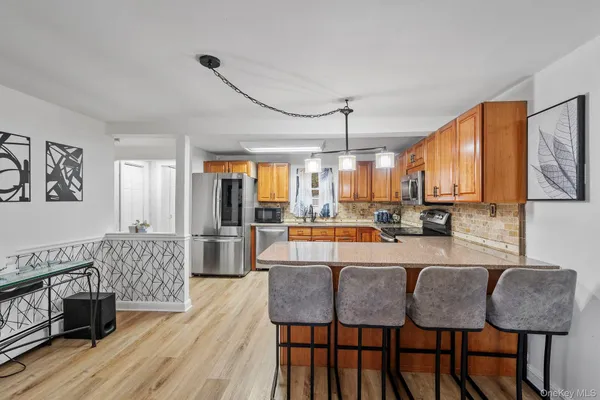 a large kitchen with a table and chairs