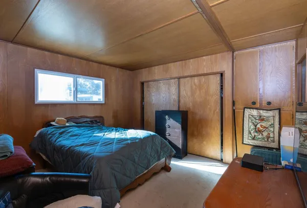 a bedroom with a bed and a window
