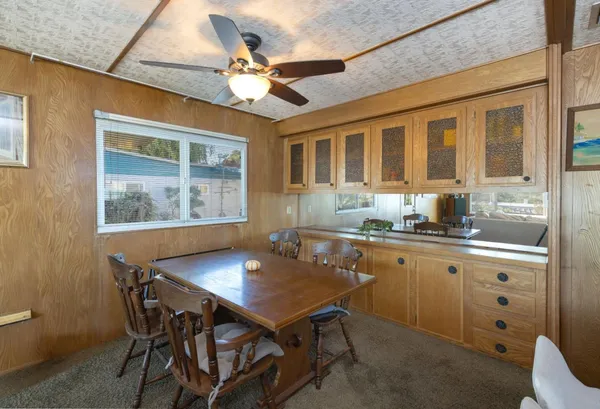 a kitchen with a table chairs and wooden floor