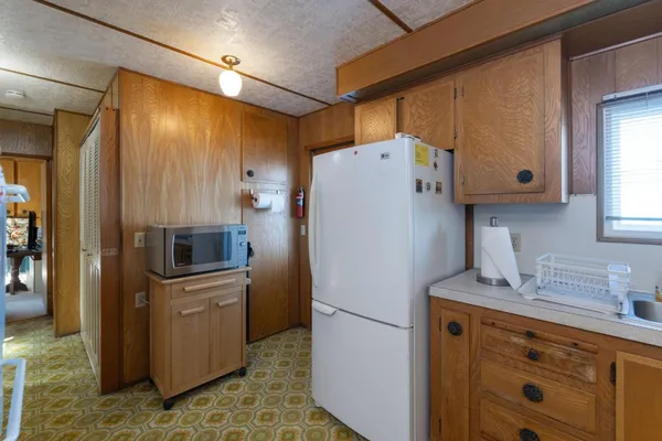 a white refrigerator freezer sitting inside of a kitchen
