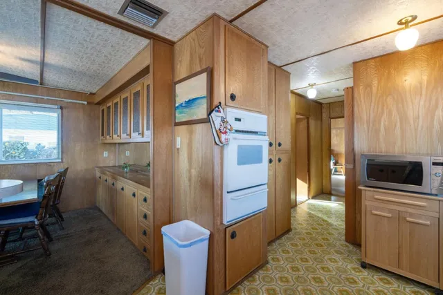 a kitchen with stainless steel appliances a refrigerator and a stove