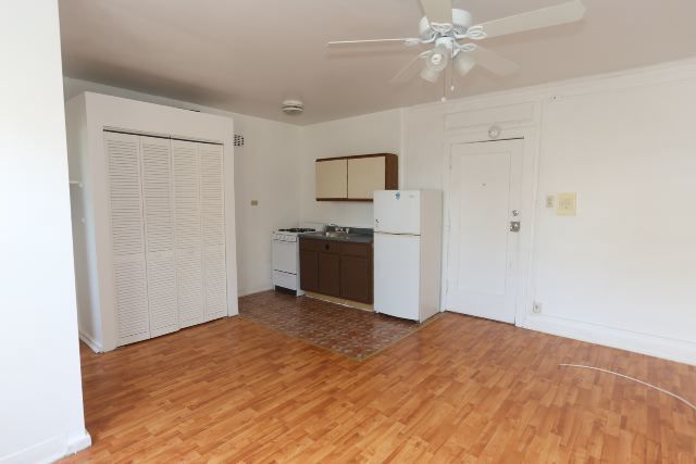 4735 North Beacon Street, Unit 211 Chicago, IL 60640 - Photo 9 of 11 a view of a kitchen with wooden floor and a ceiling fan