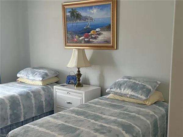 a bedroom with a bed and a painting on the wall