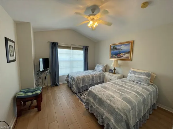 a bedroom with two beds and a chandelier