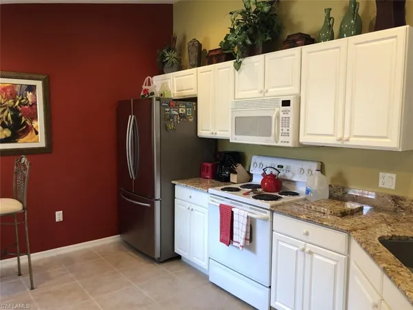 a kitchen with stainless steel appliances a refrigerator sink and cabinets