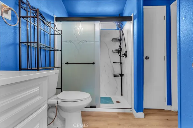 a bedroom with a bed and a painting on the wall