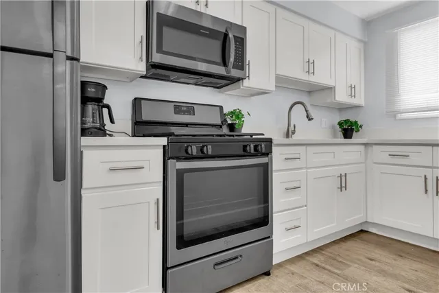 an empty room with wooden floor and ceiling fan