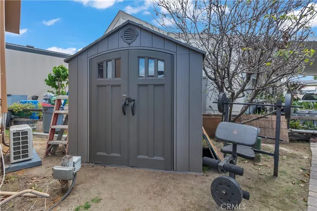 a backyard of a house with table and chairs