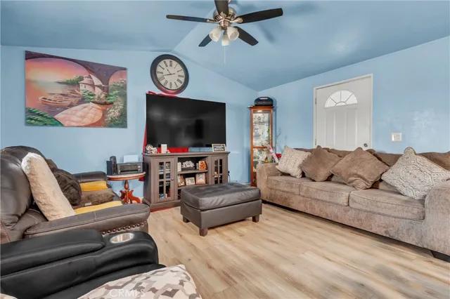 a living room with furniture and a dining table with kitchen view