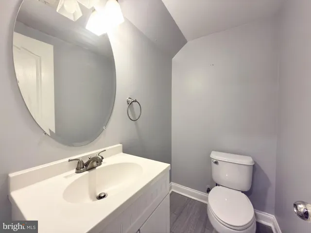 a bathroom with a sink a toilet and mirror