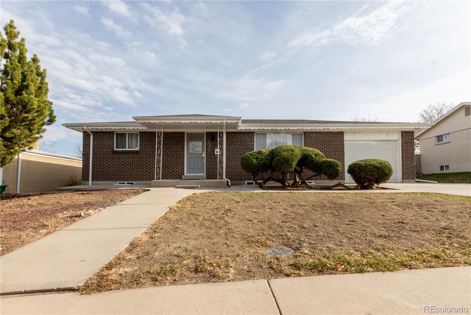 8243 Adams Way Denver, CO 80221 - Photo 1 of 27 a front view of house with yard and trees around