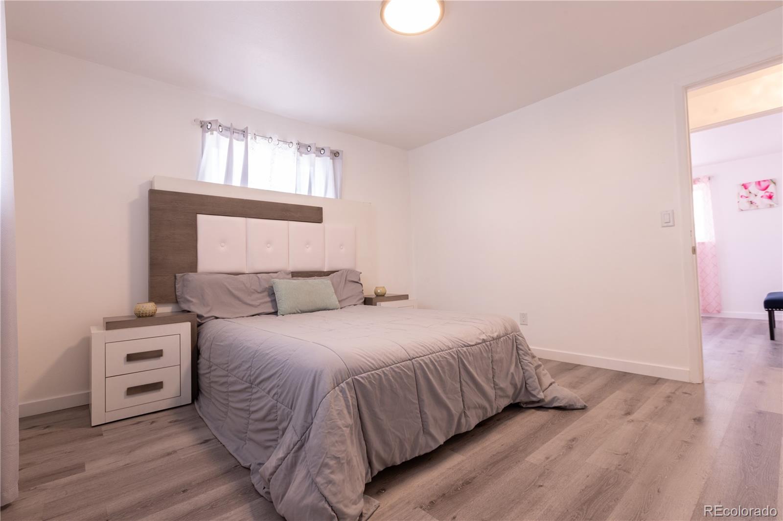 8243 Adams Way Denver, CO 80221 - Photo 13 of 27 a bedroom with a bed and a window