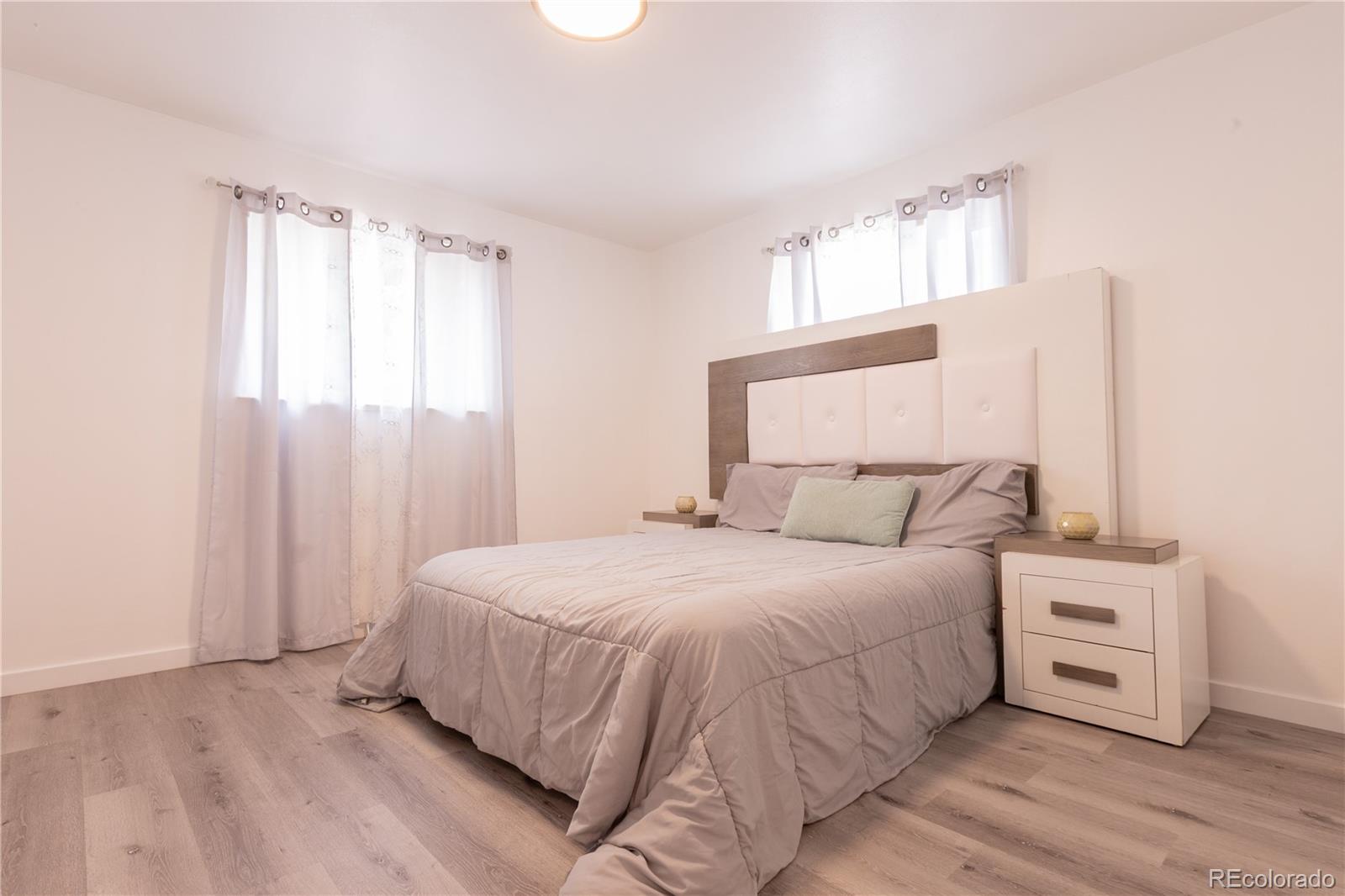 8243 Adams Way Denver, CO 80221 - Photo 14 of 27 a bedroom with a bed and a window